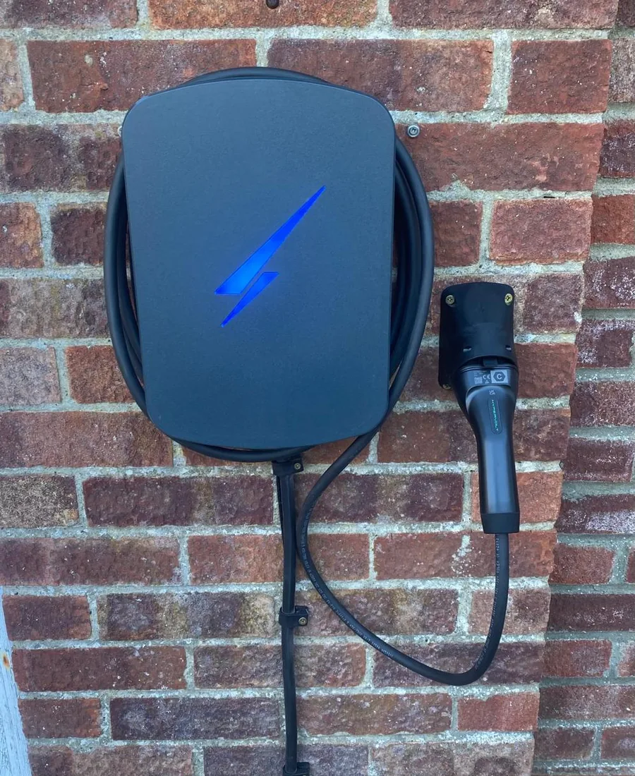Hypervolt EV charger mounted on a brick wall