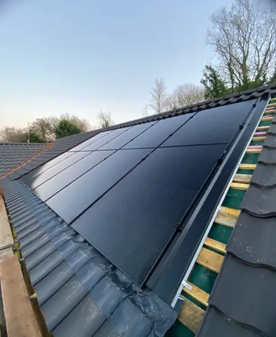 Black in-roof solar panels set flush into the tiles of a new-build roof