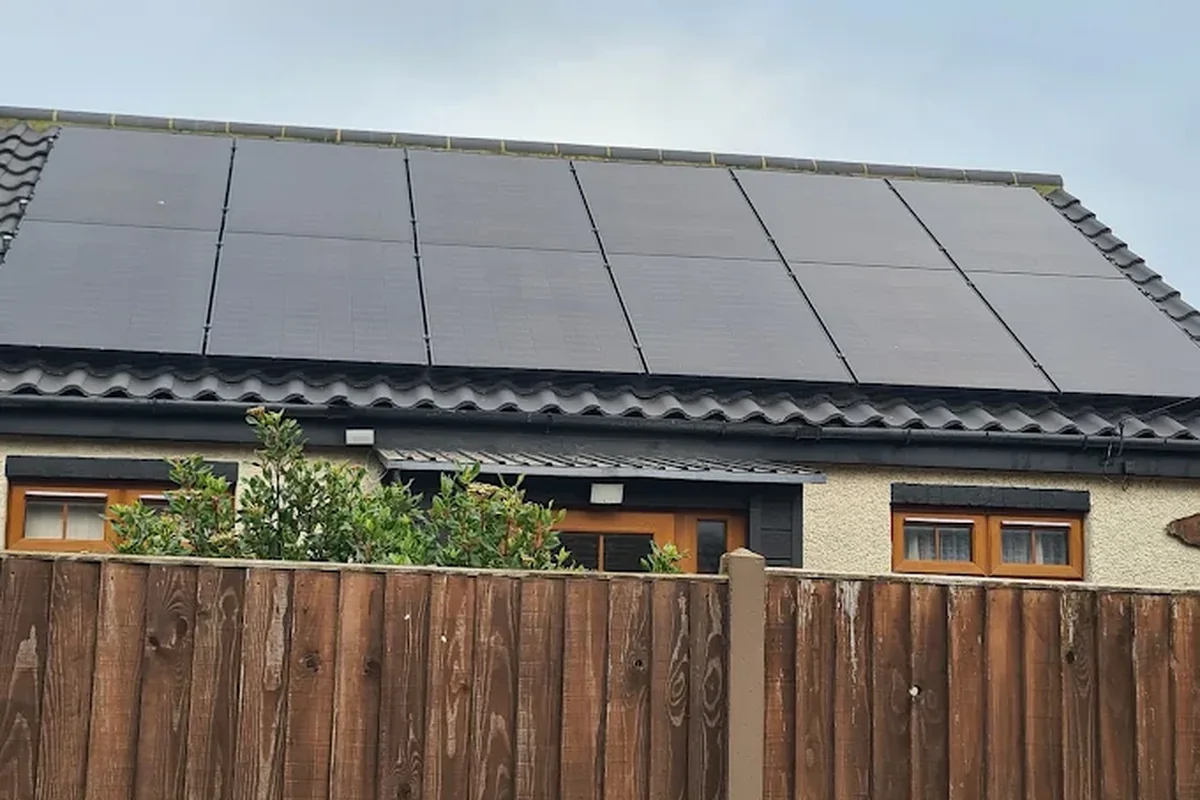 All-black solar array on a modern black-tiled roof