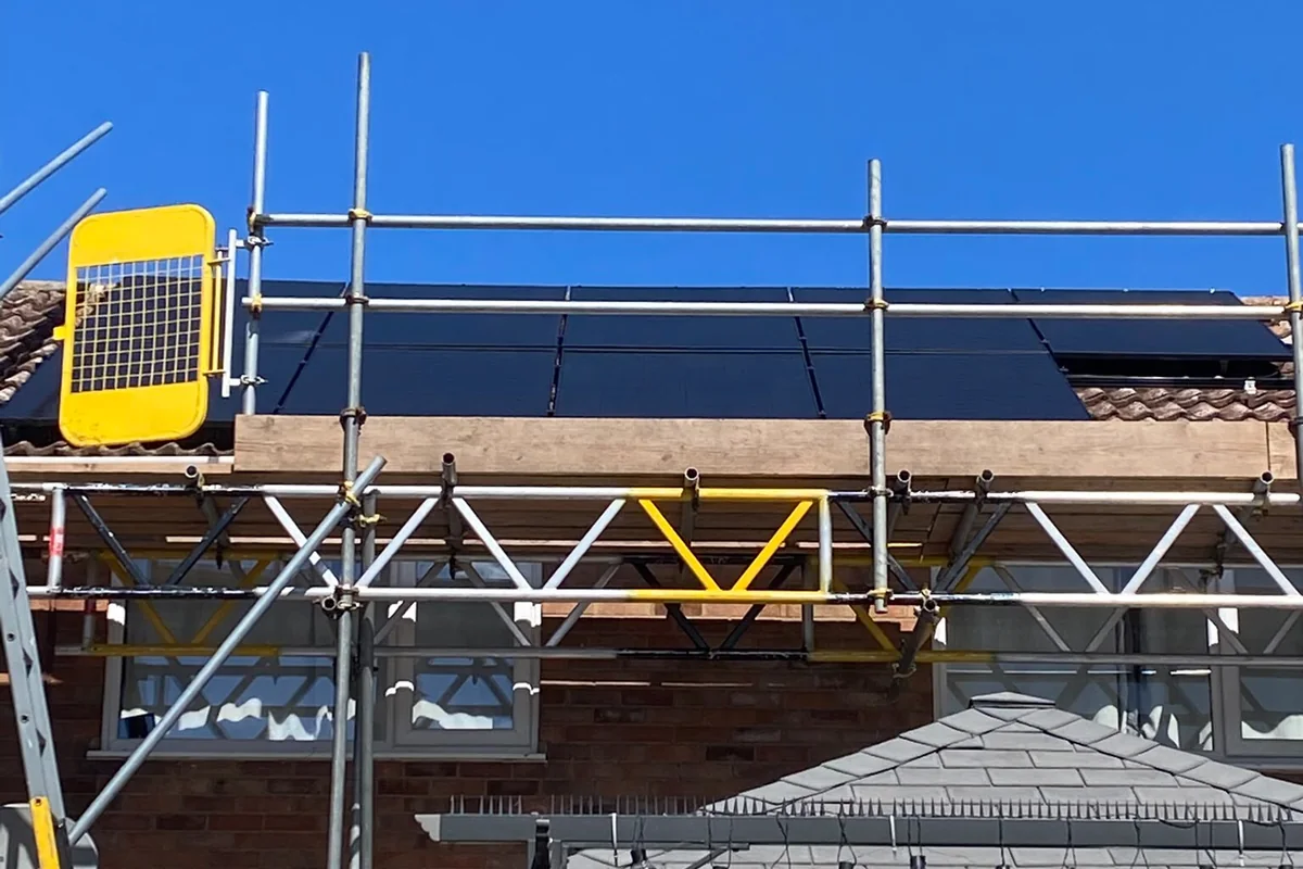 All-black panels being fitted to the roof