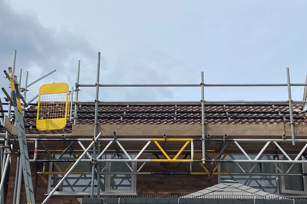 Solar panel installation in progress, scaffold up
